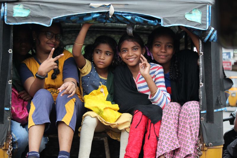 Children sitting together in an open-sided vehicle during an India mission trip