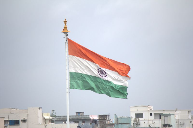 Indian flag above nearby buildings during an India mission trip