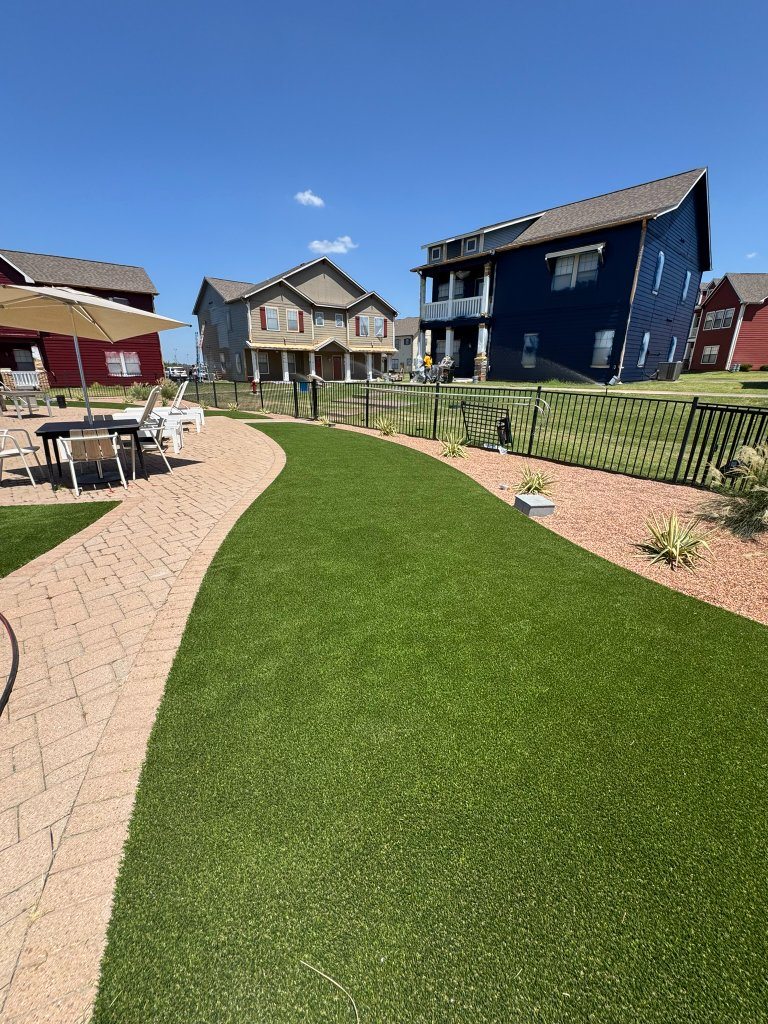 Artificial turf following a curved paver path at Cottage Row